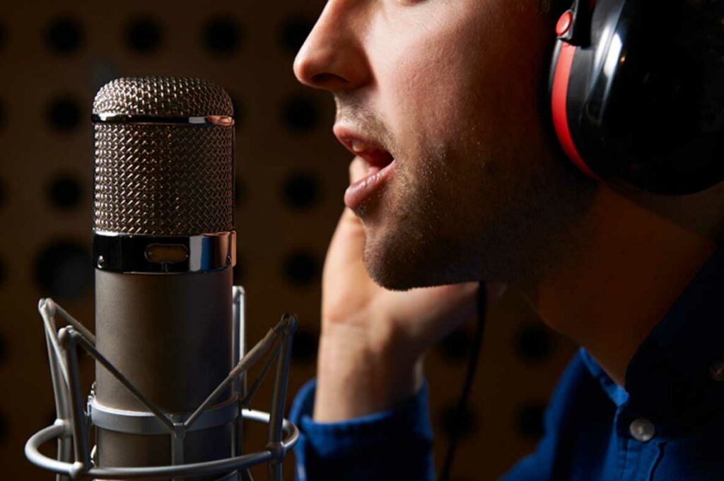 famous british voice artist at microphone