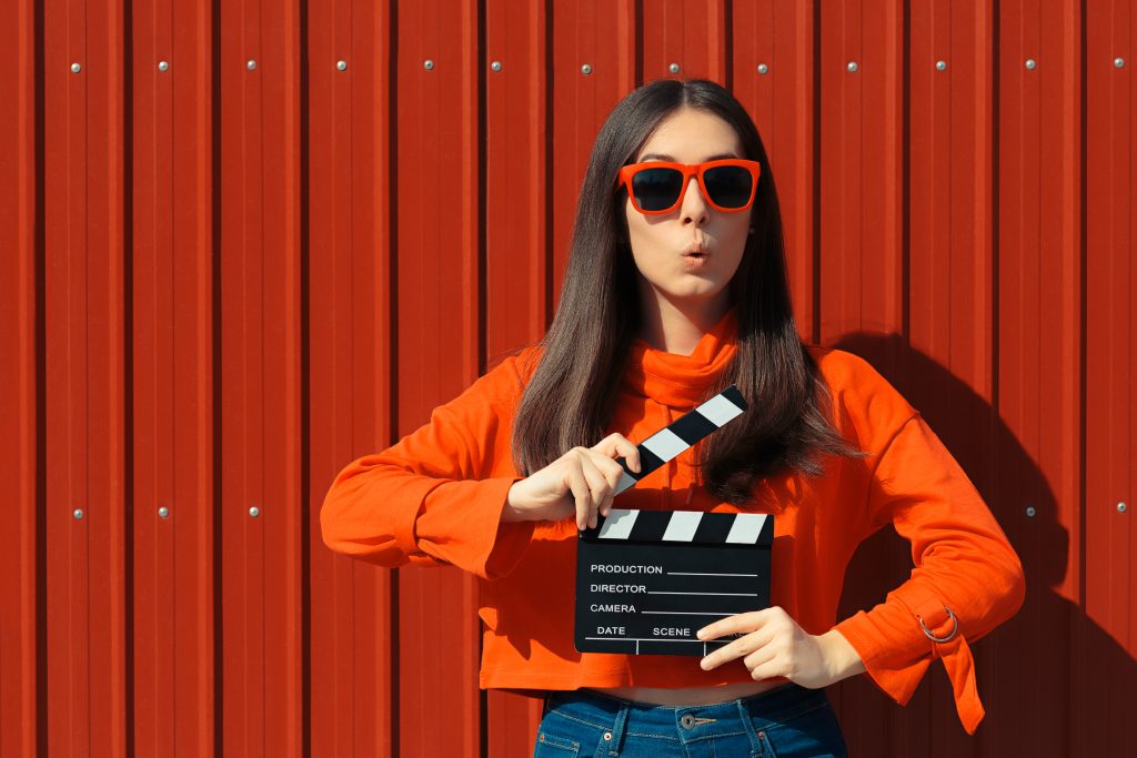 Cool model girl with film slate at casting audition